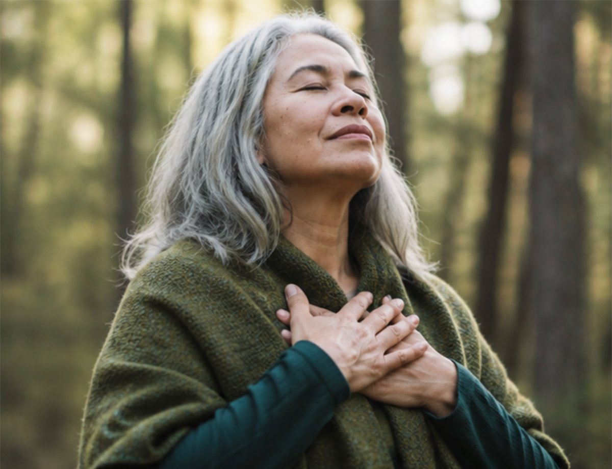 ature woman in a forest holding her hands to her heart with eyes closed ature woman in a forest holding her hands to her heart with eyes closed