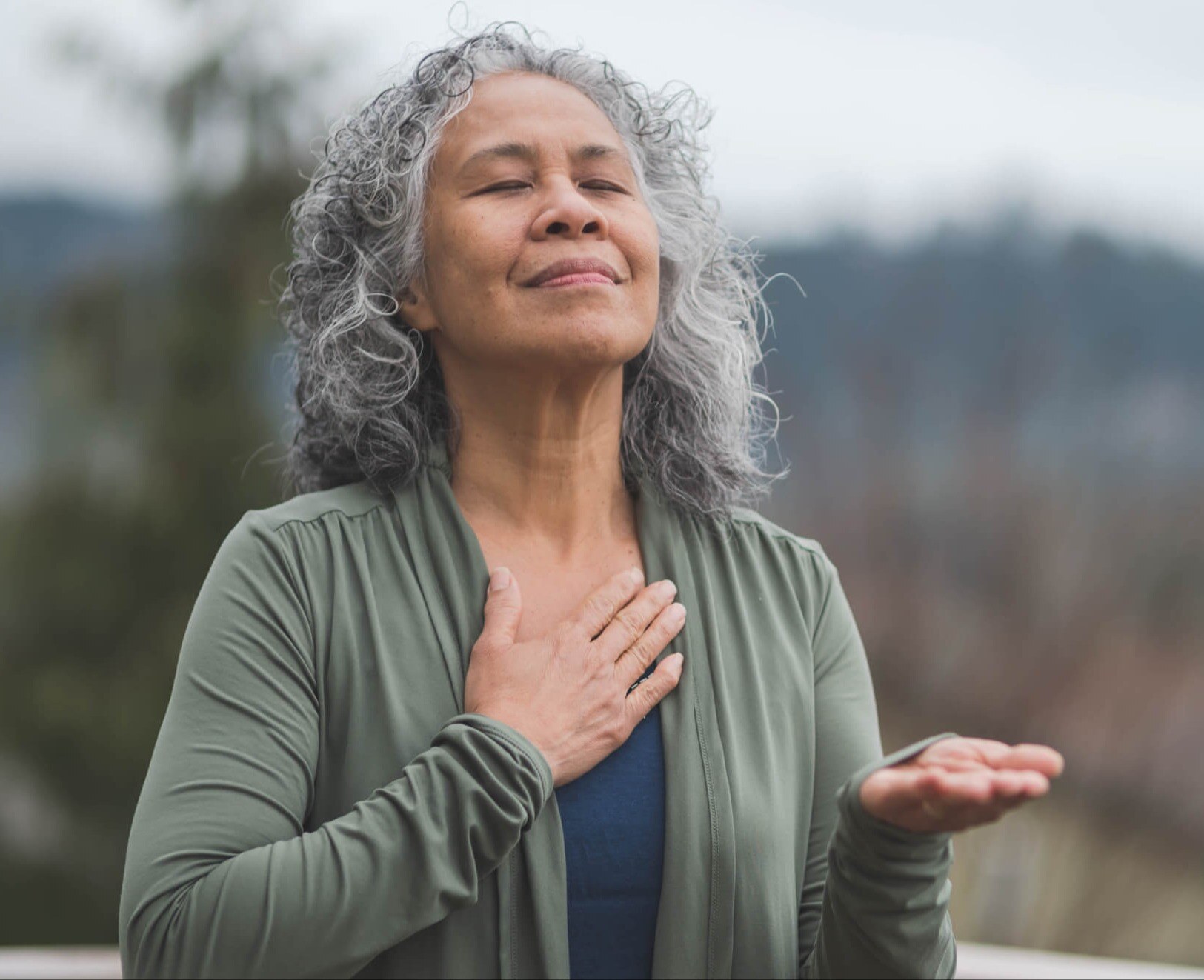 woman with a hand on her heart