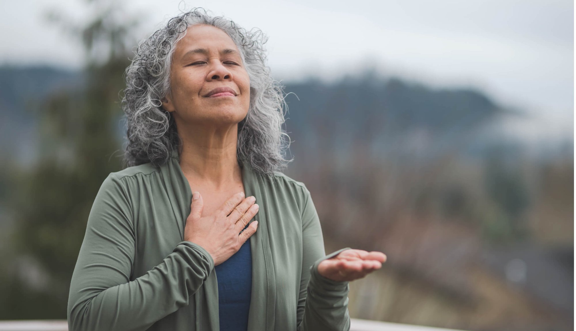 Woman holding her hand to her heart