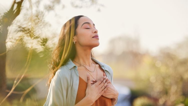 Woman with hands over her heart