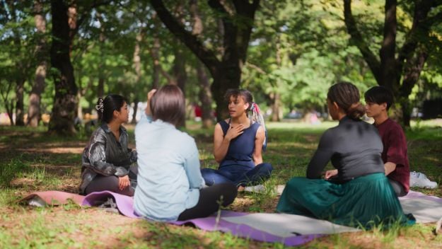 Circle of people sitting in a park