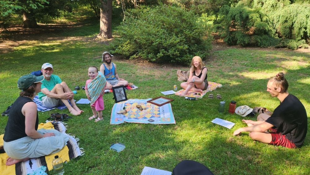 Group of people sitting in a circle in the park